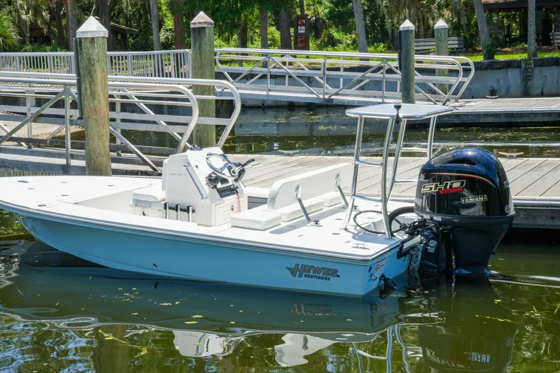 Slide: The Image of 2027 Hewes Redfisher 16 boat docked at a marina with Yamaha outboard motor. - 33