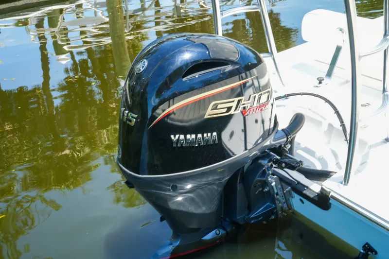 Slide: The Image of Yamaha outboard motor on 2027 Hewes Redfisher 16 boat, reflecting in calm water. - 19