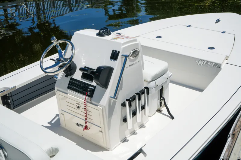 Slide: The Image of 2027 Hewes Redfisher 16 boat interior with steering console and rod holders. - 15