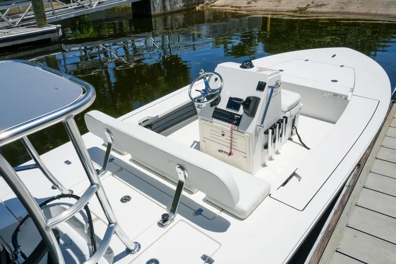 Slide: The Image of 2027 Hewes Redfisher 16 boat docked, featuring sleek design and modern controls. - 22