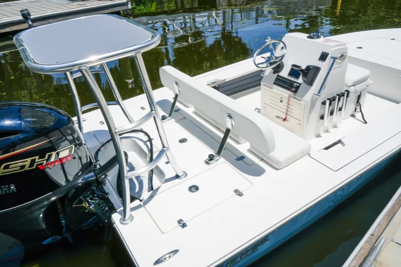 Slide: The Image of 2027 Hewes Redfisher 16 boat with Yamaha engine, docked on calm water. - 17