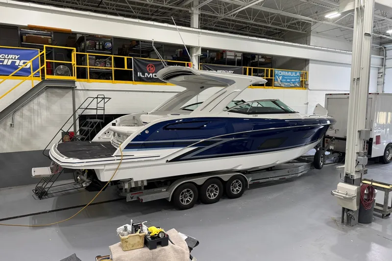 Slide: The Image of 2026 Formula 360 Crossover Bowrider I/O in a workshop setting, on a trailer. - 14