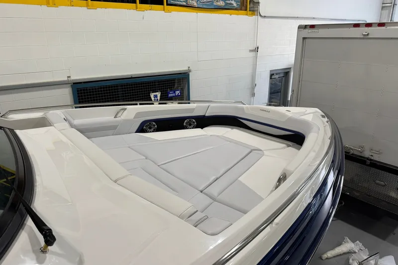 Slide: The Image of 2026 Formula 360 Crossover Bowrider I/O with sleek white seating in a showroom. - 129