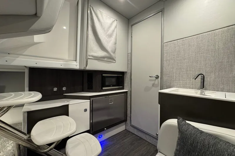 Slide: The Image of Interior of 2026 Formula 360 Crossover Bowrider I/O with kitchenette and seating area. - 142