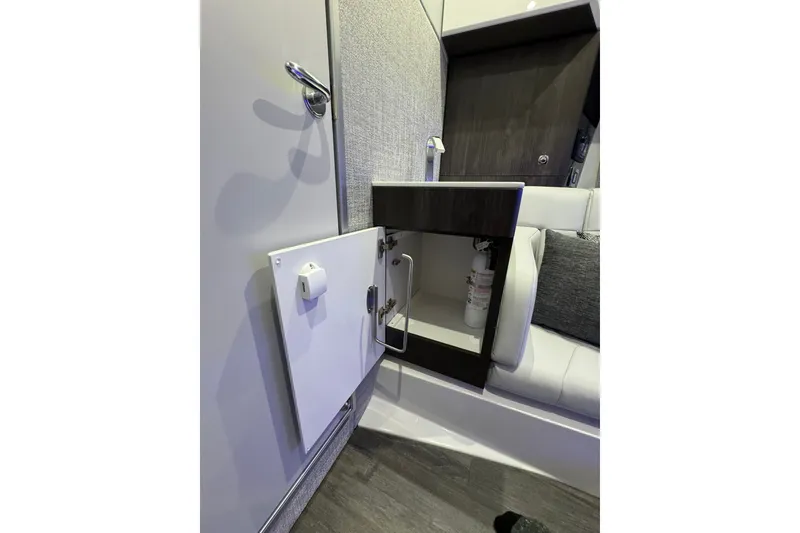 Slide: The Image of 2026 Formula 360 Crossover Bowrider I/O interior with open cabinet and fire extinguisher. - 174
