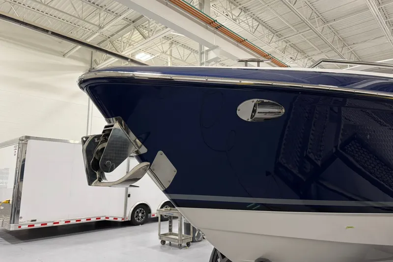 Slide: The Image of 2026 Formula 360 Crossover Bowrider I/O in showroom, showcasing sleek blue hull design. - 4