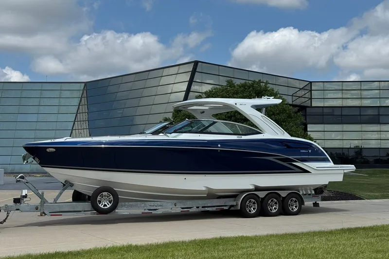 The Image of 2026 Formula 360 Crossover Bowrider I/O on trailer, modern building backdrop. - 0