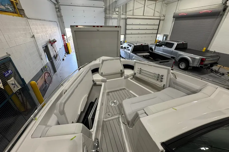 Slide: The Image of 2026 Formula 360 Crossover Bowrider I/O in a garage with trucks nearby. - 115