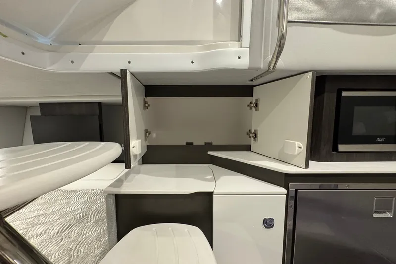 Slide: The Image of Interior of 2026 Formula 360 Crossover Bowrider I/O, featuring open cabinets and modern appliances. - 145
