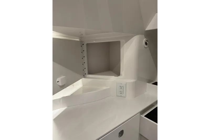 Slide: The Image of Interior of 2026 Formula 360 Crossover Bowrider I/O, featuring sleek white cabinetry and electrical outlet. - 184