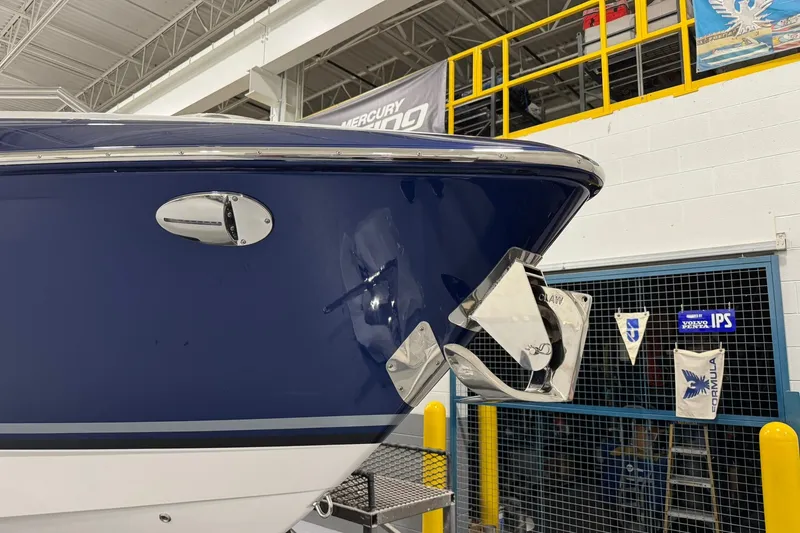 Slide: The Image of 2026 Formula 360 Crossover Bowrider I/O boat with blue hull and stainless steel anchor. - 3