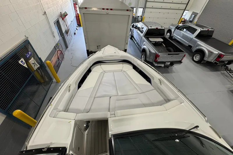 Slide: The Image of 2026 Formula 360 Crossover Bowrider I/O in a garage with trucks nearby. - 122
