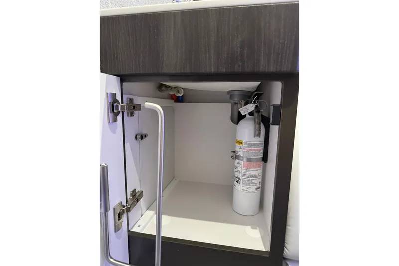 Slide: The Image of Open cabinet with fire extinguisher inside Formula 360 Crossover Bowrider I/O, 2026 model. - 175