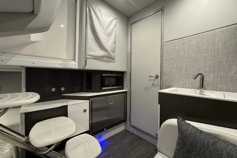 Slide: The Image of Interior of 2026 Formula 360 Crossover Bowrider I/O with modern kitchenette and seating area. - 143