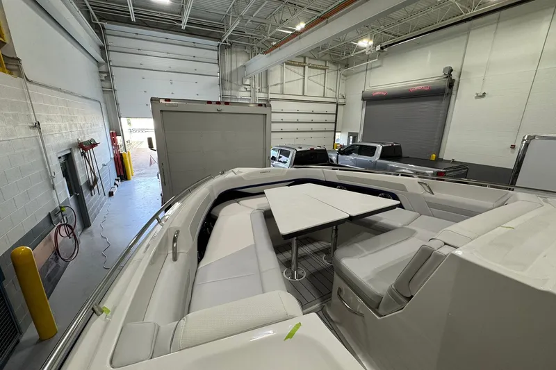 Slide: The Image of 2026 Formula 360 Crossover Bowrider I/O in a garage, showcasing spacious seating and table. - 118