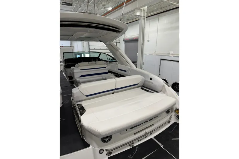 Slide: The Image of 2026 Formula 360 Crossover Bowrider I/O with luxurious white seating in a showroom. - 16