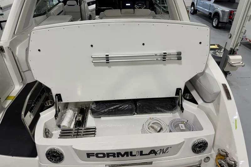 Slide: The Image of 2026 Formula 360 Crossover Bowrider I/O boat storage compartment with accessories and equipment. - 20