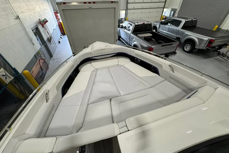 Slide: The Image of 2026 Formula 360 Crossover Bowrider I/O with spacious seating in a garage setting. - 123