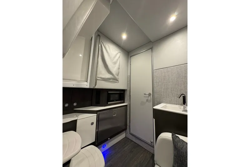 Slide: The Image of Interior of 2026 Formula 360 Crossover Bowrider I/O, featuring modern kitchenette and seating. - 140