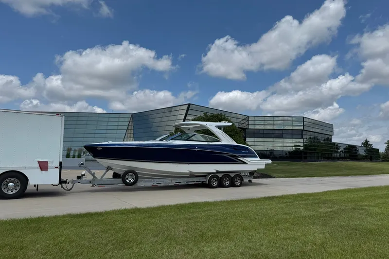 Slide: The Image of 2026 Formula 360 Crossover Bowrider I/O on trailer, modern building background. - 1