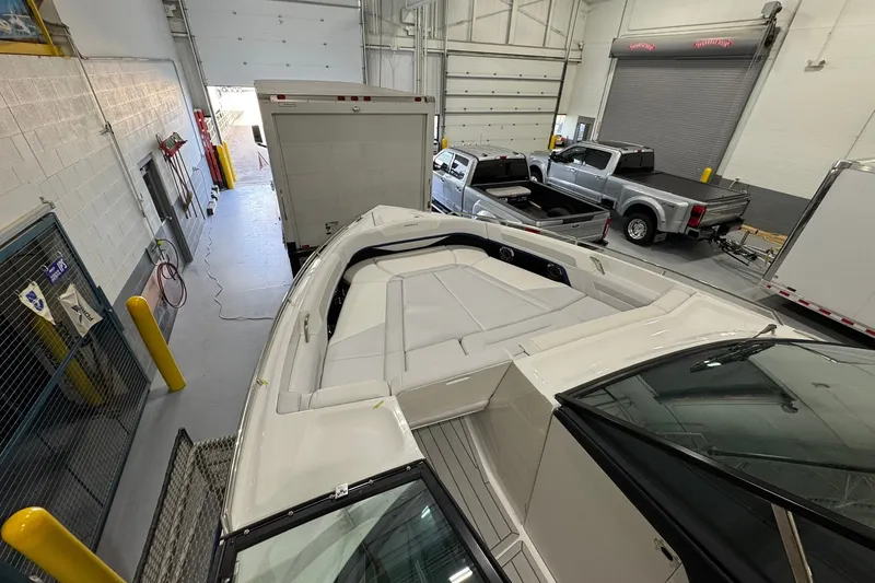 Slide: The Image of 2026 Formula 360 Crossover Bowrider I/O in a garage with trucks and equipment. - 121