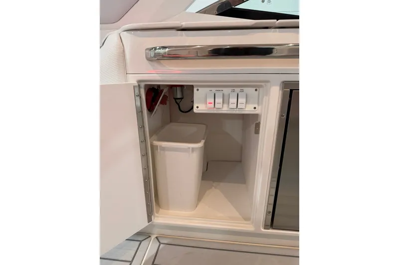 Slide: The Image of 2026 Formula 360 Crossover Bowrider I/O interior cabinet with switches and trash bin. - 36