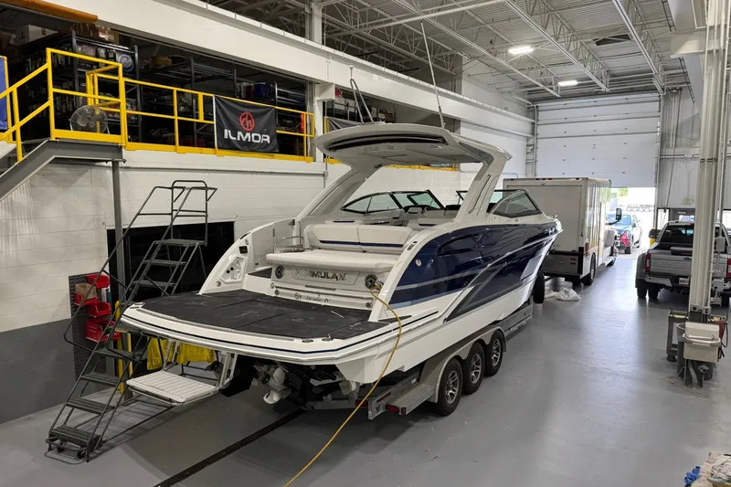 Slide: The Image of 2026 Formula 360 Crossover Bowrider I/O in a garage, showcasing sleek design and luxury features. - 13