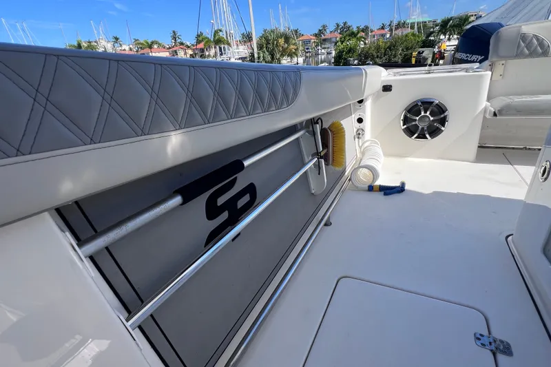 Slide: The Image of 2022 Sea Pro 320 DLX Offshore boat interior with speaker and storage features. - 48