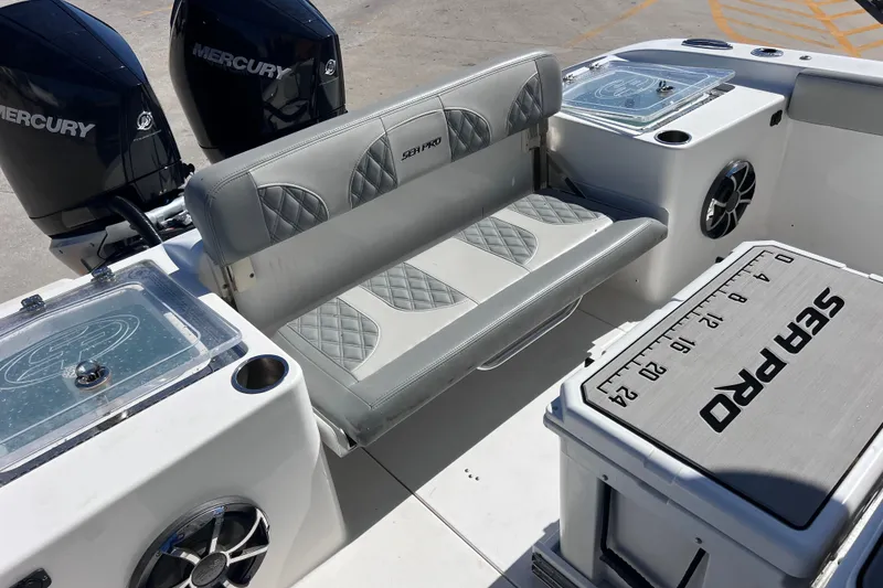 Slide: The Image of 2022 Sea Pro 320 DLX Offshore boat interior with seating and Mercury engines. - 39