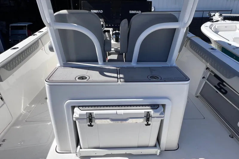Slide: The Image of 2022 Sea Pro 320 DLX Offshore boat interior with seating and storage compartments. - 37