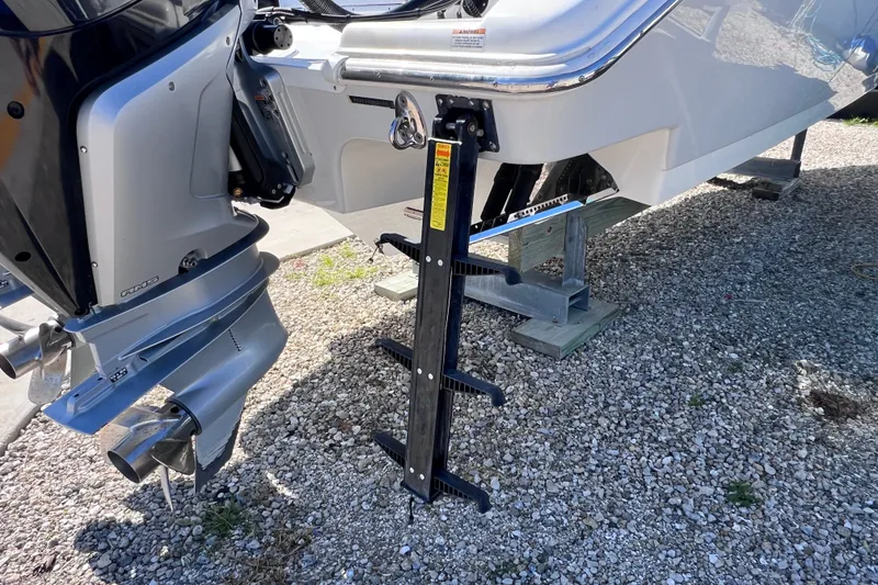 Slide: The Image of 2022 Sea Pro 320 DLX Offshore boat with outboard motor and ladder on gravel. - 25