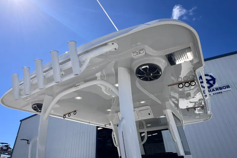 Slide: The Image of 2022 Sea Pro 320 DLX Offshore boat with rod holders and speakers under a clear blue sky. - 78