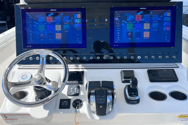 Slide: The Image of Control panel of 2022 Sea Pro 320 DLX Offshore boat with dual Simrad displays. - 52