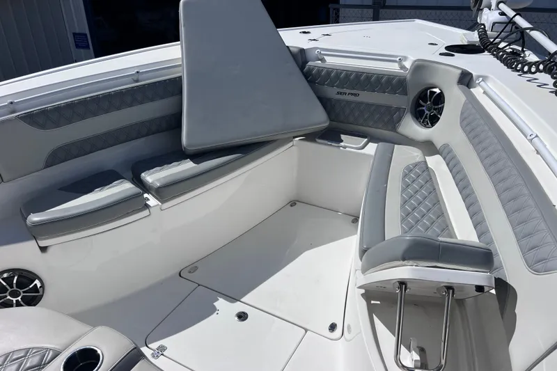 Slide: The Image of 2022 Sea Pro 320 DLX Offshore boat interior with cushioned seating and speaker system. - 67