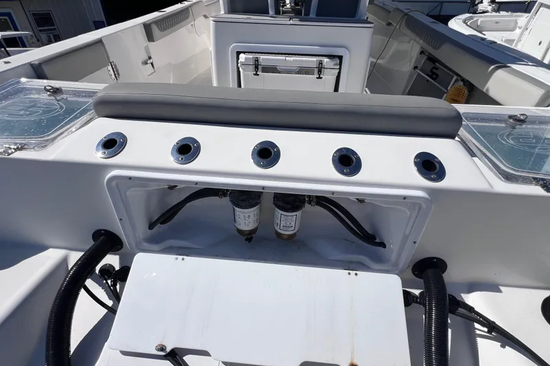 Slide: The Image of 2022 Sea Pro 320 DLX Offshore boat interior with rod holders and storage compartments. - 29