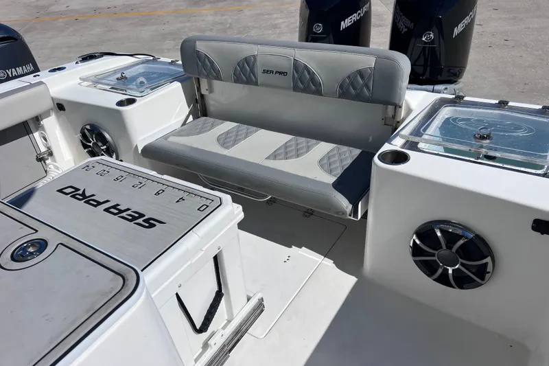 Slide: The Image of 2022 Sea Pro 320 DLX Offshore boat interior with seating and storage compartments. - 40