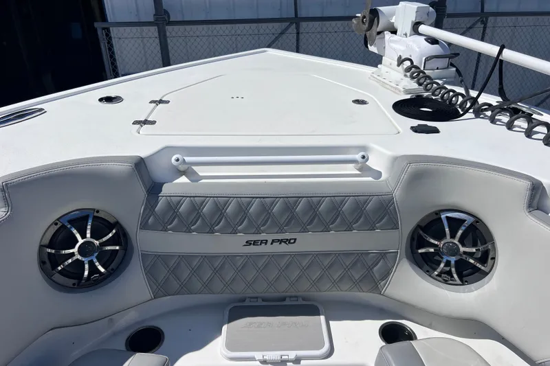 Slide: The Image of 2022 Sea Pro 320 DLX Offshore boat interior with speakers and diamond-stitched upholstery. - 69