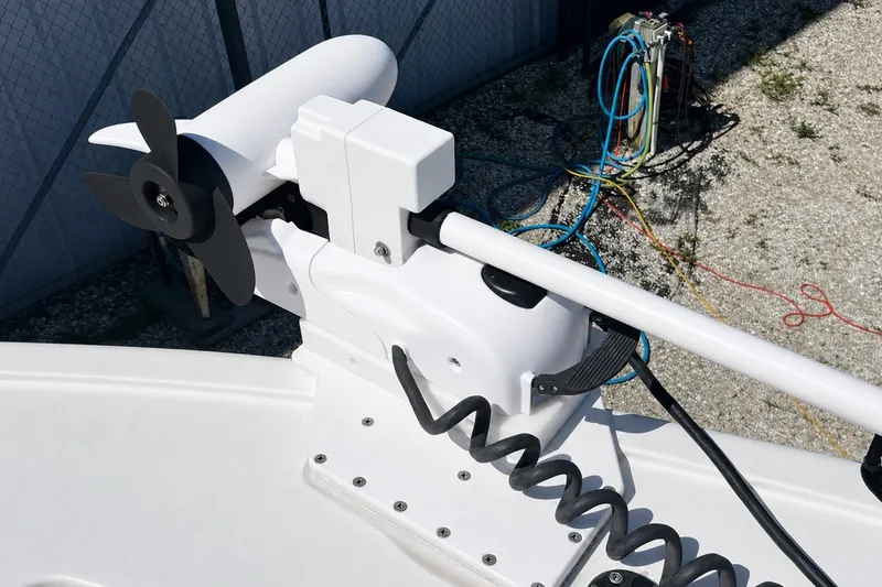 Slide: The Image of Trolling motor on 2022 Sea Pro 320 DLX Offshore boat, docked with visible cables. - 71