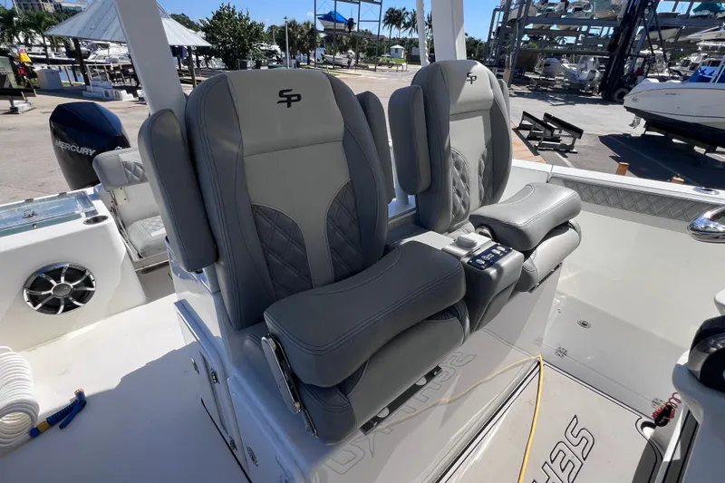 Slide: The Image of 2022 Sea Pro 320 DLX Offshore boat with dual gray captain's chairs and Mercury engine. - 50