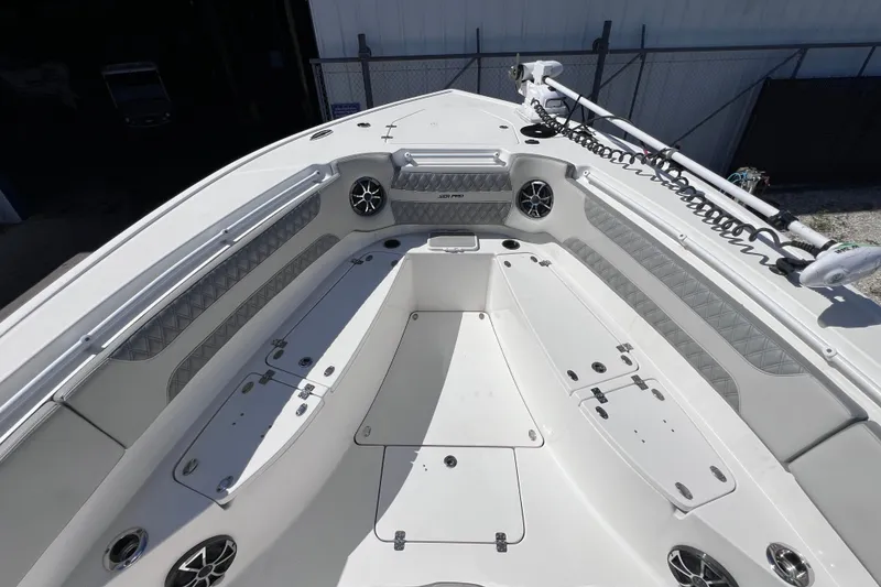 Slide: The Image of 2022 Sea Pro 320 DLX Offshore boat deck with seating and storage compartments. - 66