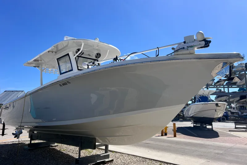 Slide: The Image of 2022 Sea Pro 320 DLX Offshore boat displayed outdoors under clear blue sky. - 19