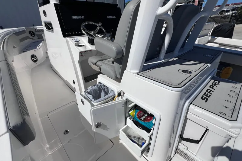 Slide: The Image of 2022 Sea Pro 320 DLX Offshore boat interior with helm, storage, and seating. - 43