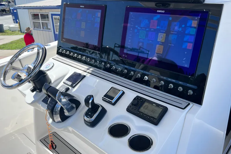 Slide: The Image of 2022 Sea Pro 320 DLX Offshore helm with dual Simrad displays and advanced controls. - 53