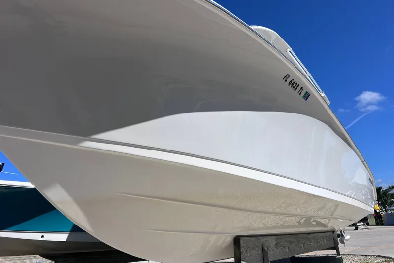 Slide: The Image of 2022 Sea Pro 320 DLX Offshore boat on display under clear blue sky. - 21