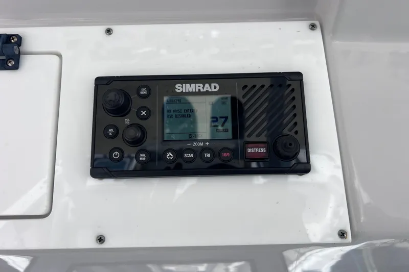 Slide: The Image of Simrad marine radio on 2022 Sea Pro 320 DLX Offshore boat dashboard. - 82