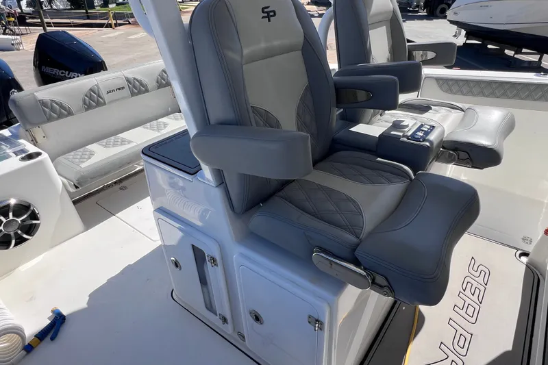 Slide: The Image of 2022 Sea Pro 320 DLX Offshore boat interior with luxurious seating and modern controls. - 41