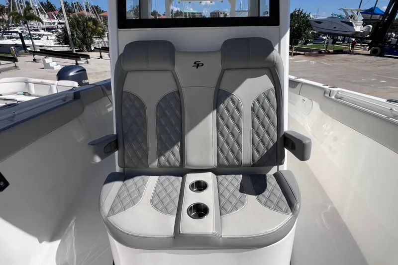 Slide: The Image of 2022 Sea Pro 320 DLX Offshore boat seating with cup holders, docked at marina. - 76