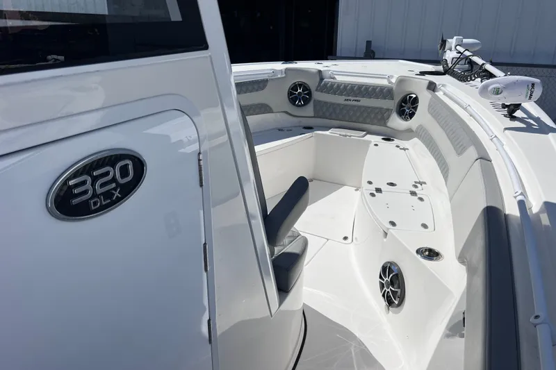 Slide: The Image of 2022 Sea Pro 320 DLX Offshore boat interior with seating and speakers. - 65