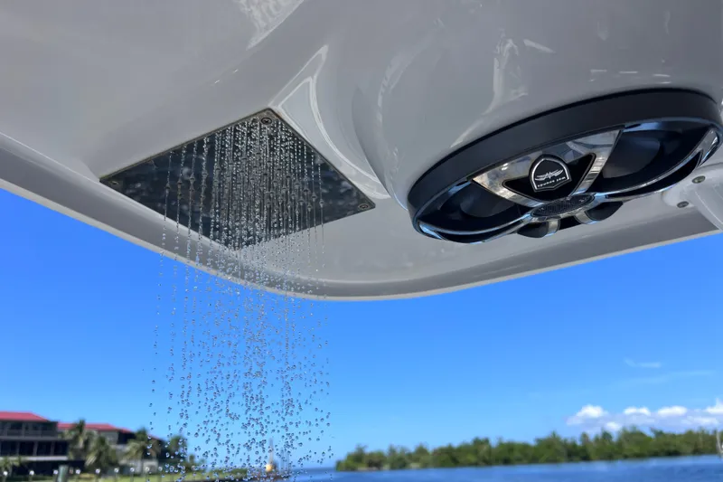 Slide: The Image of Outdoor shower and speaker on 2022 Sea Pro 320 DLX Offshore boat, with scenic water view. - 81
