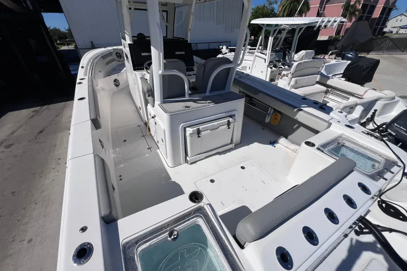 Slide: The Image of 2022 Sea Pro 320 DLX Offshore boat interior with seating and storage compartments. - 31